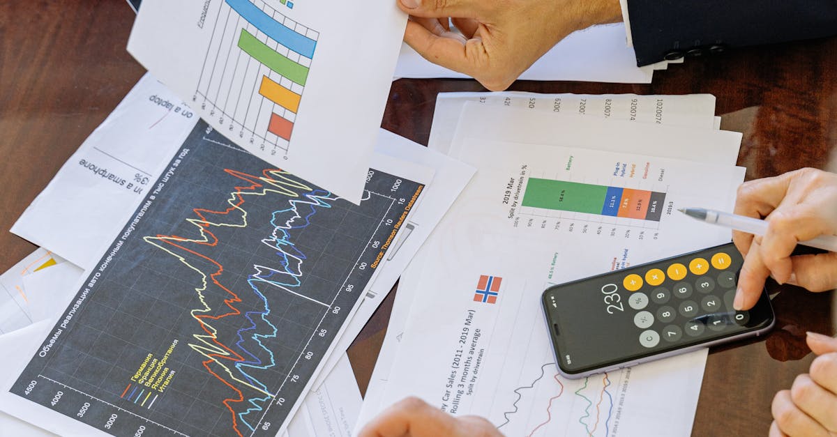 Business professionals analyzing financial charts and graphs during a meeting.